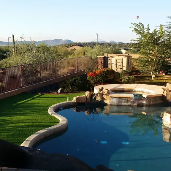 Lagoon pool and spa with lawn and mountain view