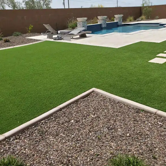 Artificial turf with gravel border next to a pool