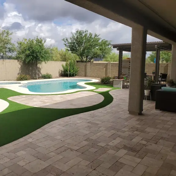 Paver patio with turf strip and small pool