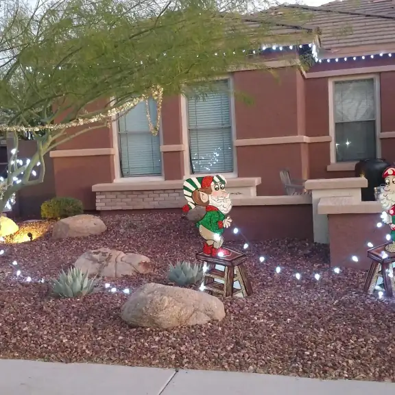 Front yard decorated with Christmas lights and figures