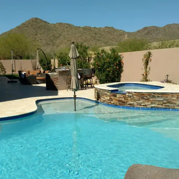 Freeform pool and raised spa with mountain view