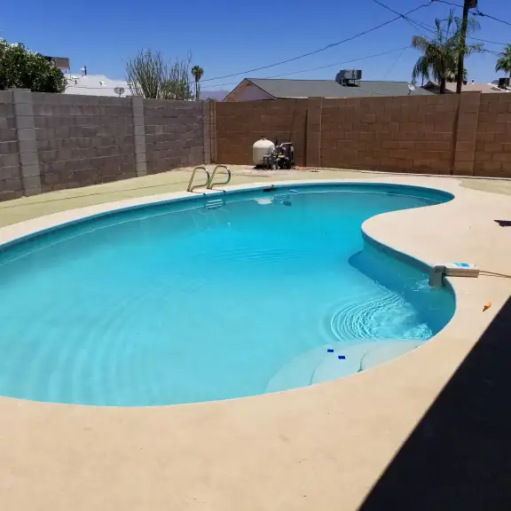 Kidney pool with technician by a block wall