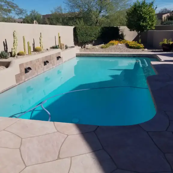 Bright pool with deck jets and cactus planters
