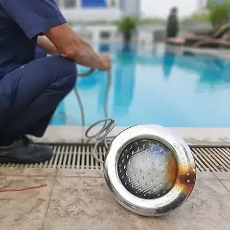 Technician repairing a pool light (square)