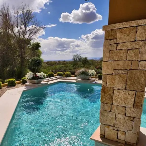 Sparkling pool next to a stone column (square)