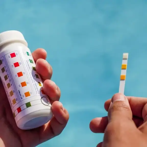Hand holding pool test strips (square)
